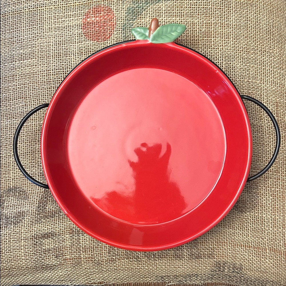 Avon Red Apple ceramic pie plate with a black metal cooling rack.